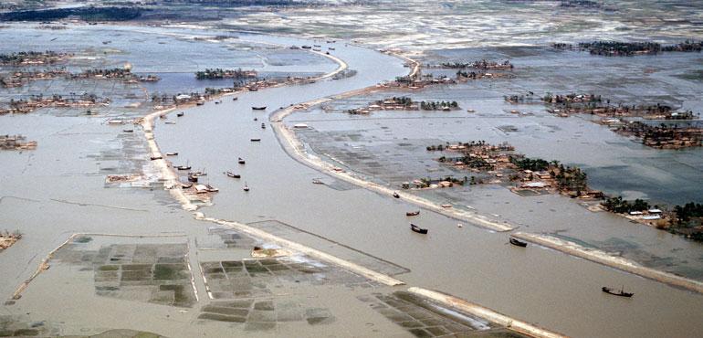 Flooded villages and fields around a river in Bangladesh the day after the 1991 Bangladesh cyclone had struck the country. (Staff Sergeant Val Gempis (USAF)/Wikimedia Commons)