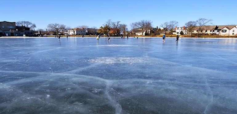 People skating on a frozen pond on a clear day. (Image by Q K from Pixabay)