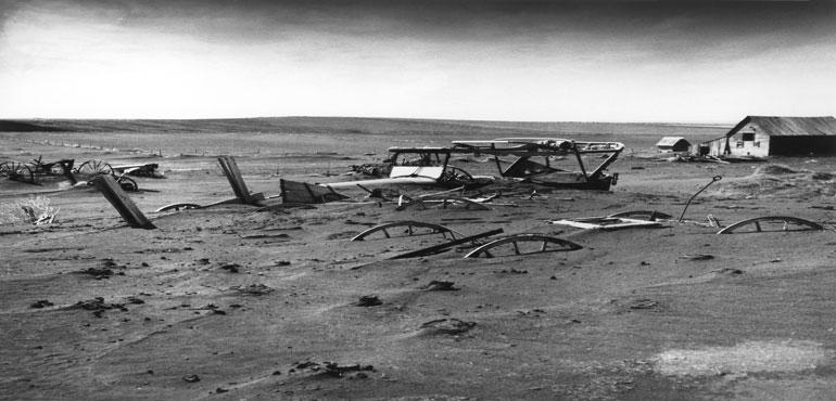 Buried machinery in barn lot in Dallas, South Dakota, United States during the Dust Bowl, an agricultural, ecological, and economic disaster in the Great Plains region of North America in 1936. (Wikimedia Commons/USDA)